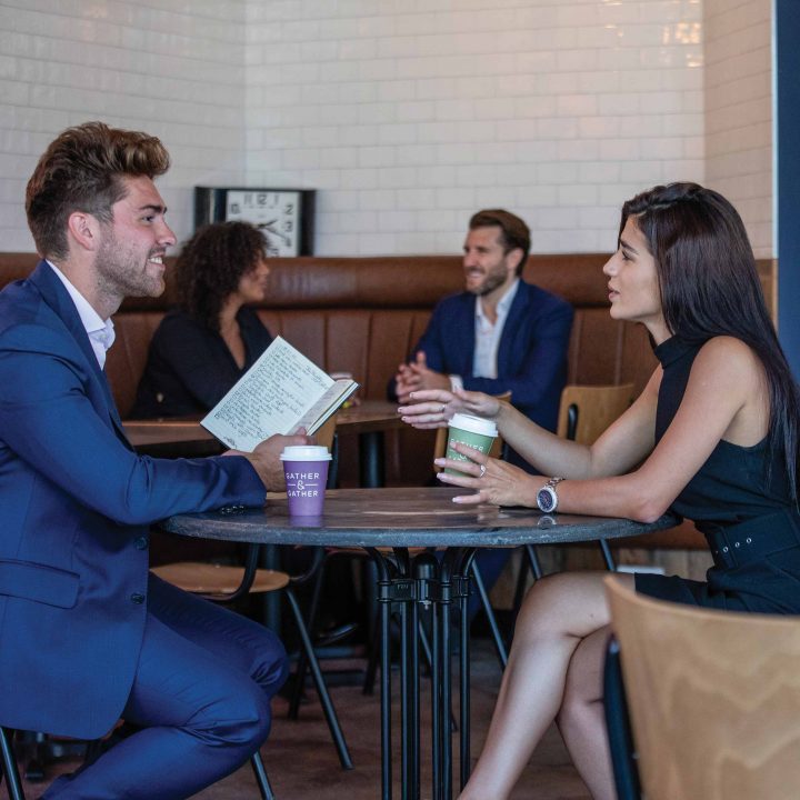 Two people sitting near table