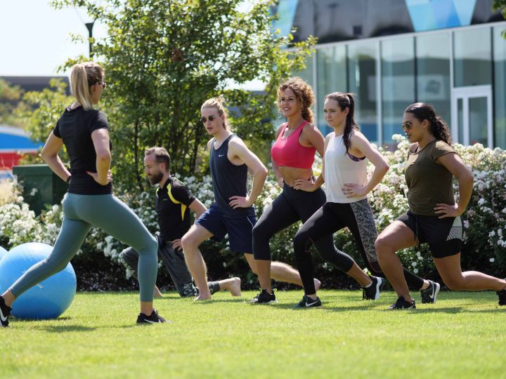 people attending pilates 4 your wellbeing fitness event outside in the park